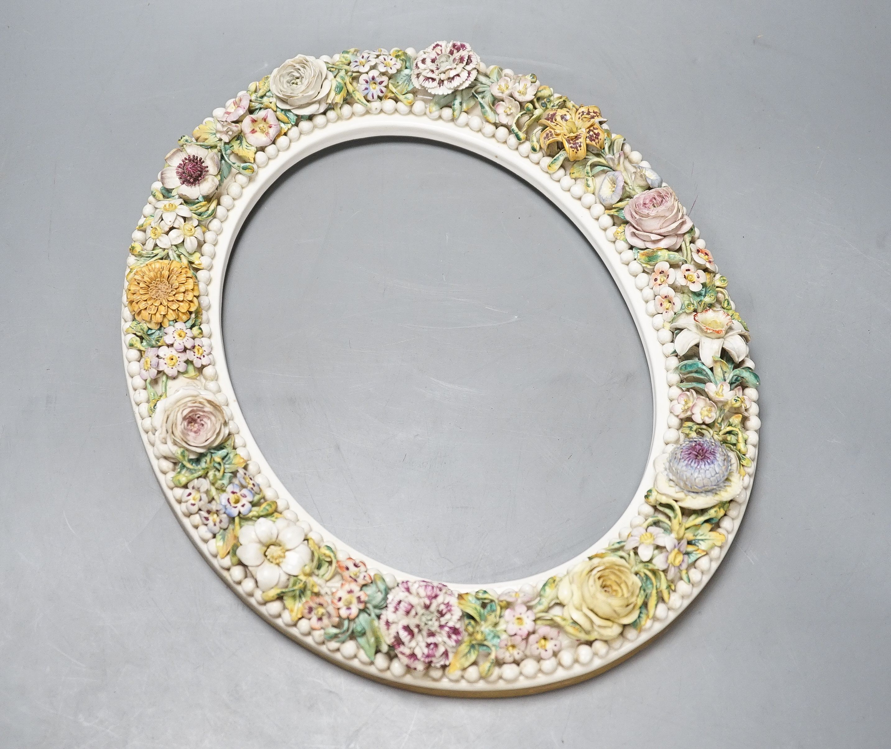 A 19th century English porcelain floral encrusted oval frame 32cm